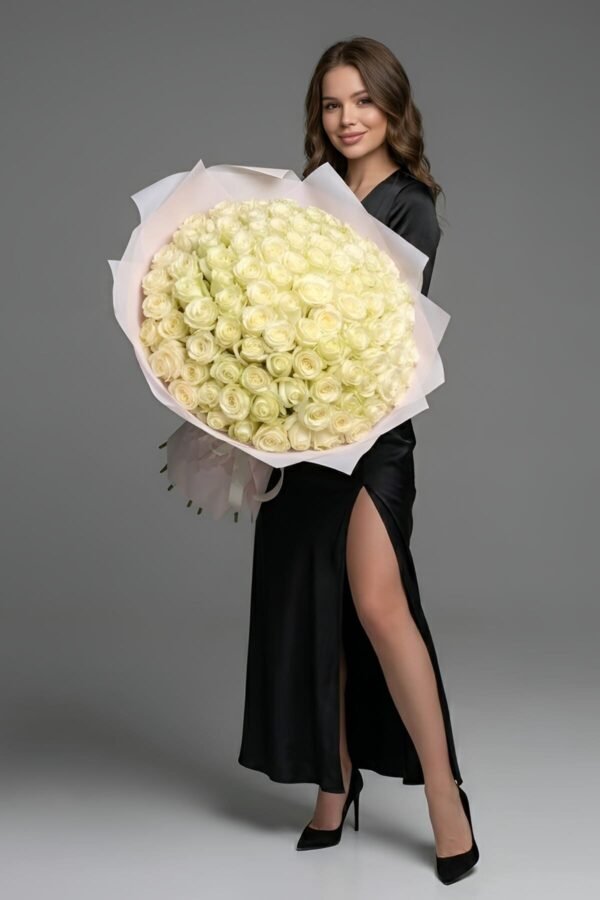 100 White Roses Bouquet, the ultimate symbol of purity and reverence, composed of 100 pristine white roses, delivered same day in London by The London Bloom.