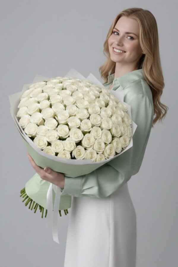 100 White Roses Bouquet, the ultimate symbol of purity and reverence, composed of 100 pristine white roses, delivered same day in London by The London Bloom.