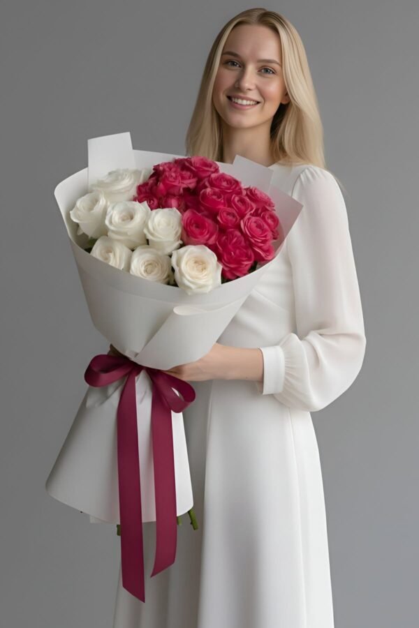 A blonde woman in a white dress holding a luxury bouquet featuring White Peony O'Hara roses, Country Blue roses, Pink Roses and Silva Pink roses with a plum ribbon.