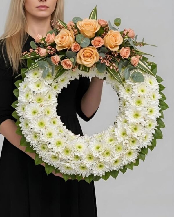 Dignified Chrysanthemum and Rose Wreath by The London Bloom featuring orange roses, delicate spray roses, and premium chrysanthemums.