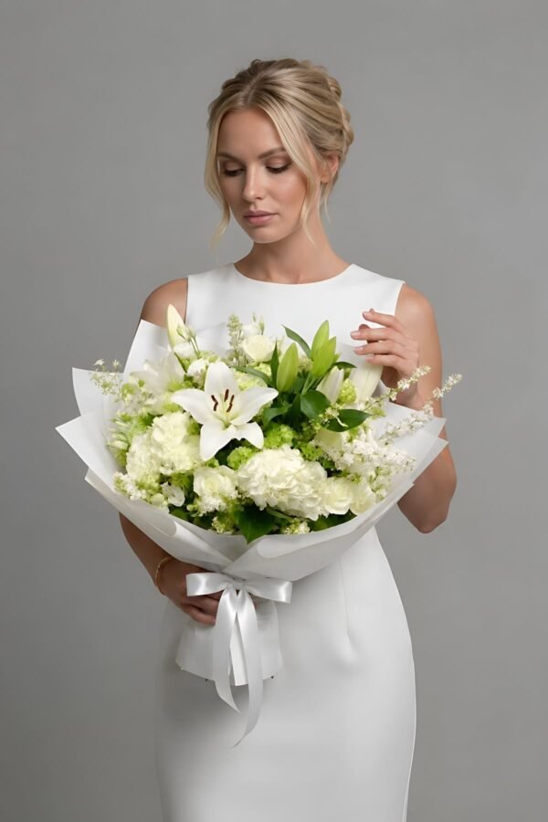 Peaceful Garden Bouquet featuring white hydrangeas, white roses, white lilies, and wax flower, delivered same day in London by The London Bloom.