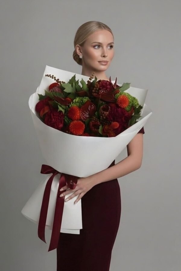 Luxury Art Bouquet by The London Bloom featuring burgundy anthurium, protea, red calla lilies, and dark red hydrangeas in a sculptural floral arrangement.