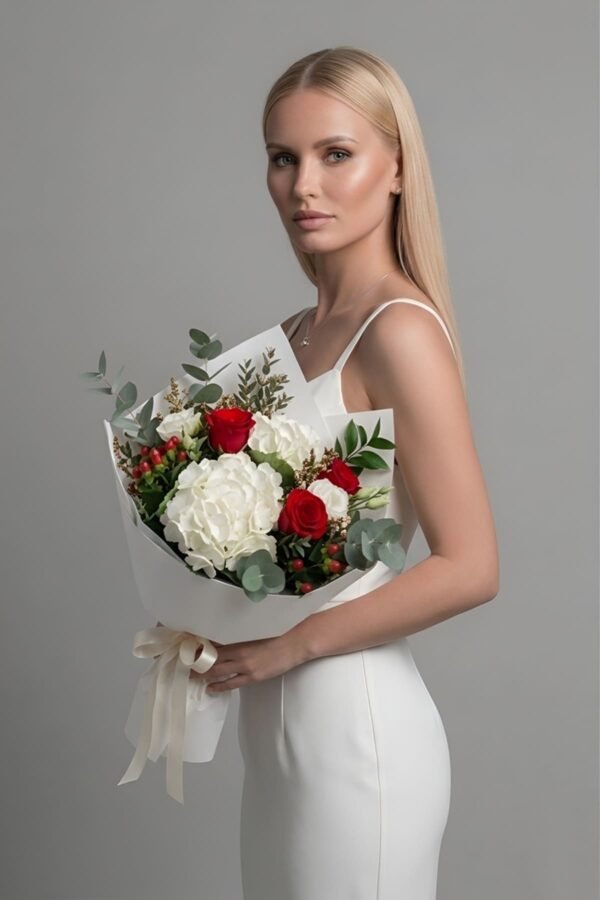 The Art Bouquet containing white hydrangeas, red roses, white lisianthus, and green foliage.