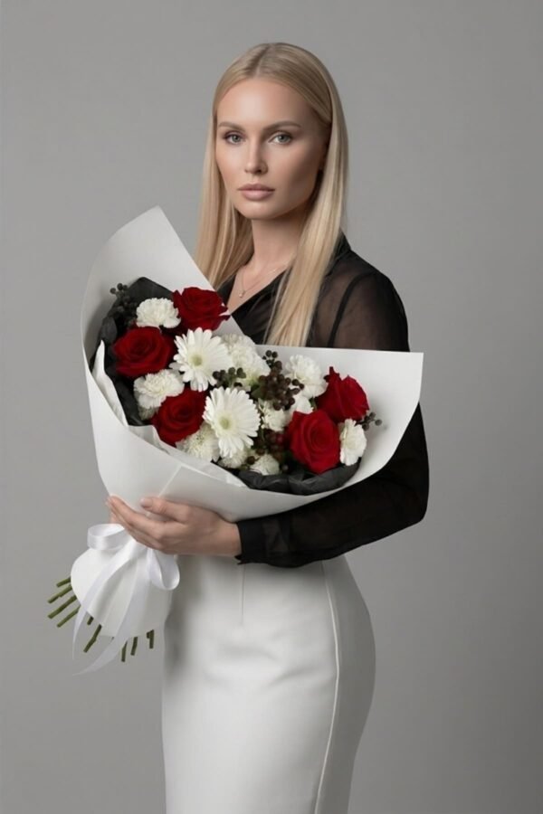 The Beauty of Contrast bouquet by The London Bloom featuring red roses, white carnations, white gerberas, and red hypericum berries in luxury gift wrap.