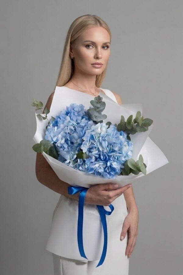 Luxury Blue Hydrangea and Eucalyptus Bouquet by The London Bloom featuring large blue hydrangea heads and fresh eucalyptus branches.