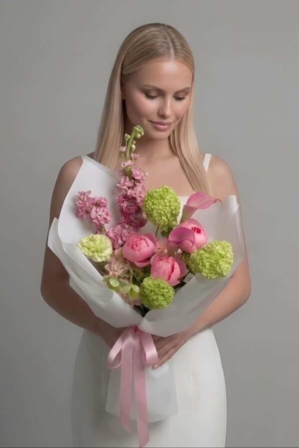 A luxury 'Summer Kiss Bouquet' by The London Bloom, featuring a vibrant array of Sarah Bernhardt peonies, pink callas, hydrangeas, matthiolas, and fresh viburnum.