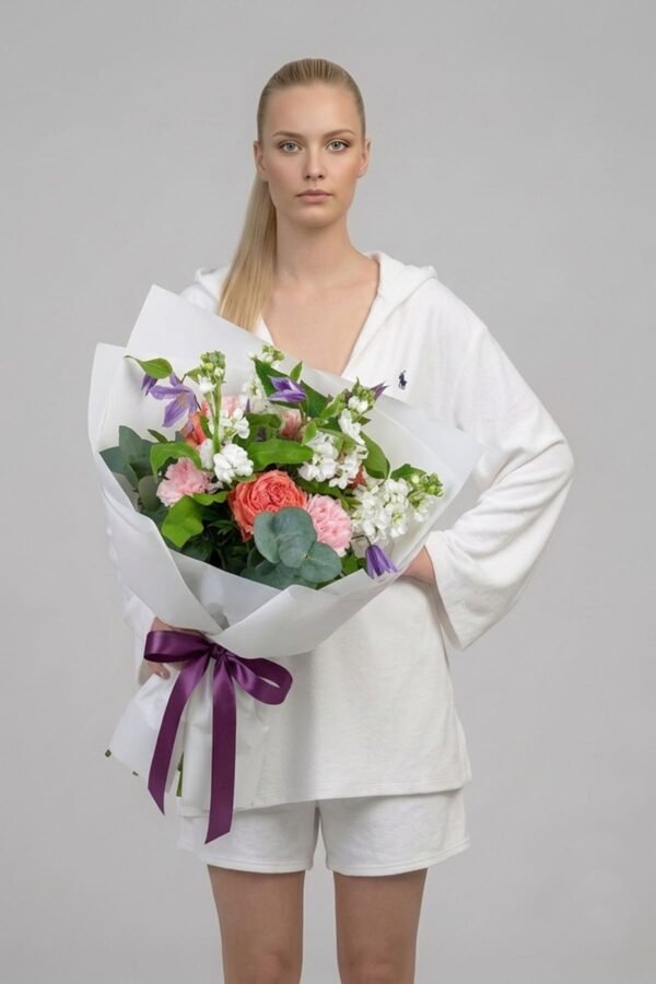Be Happy Bouquet by The London Bloom featuring peach Kahala roses, light purple clematis, white matthiola, and green eucalyptus leaves.